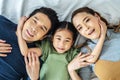 Top view of Happy Asian beautiful young mother, father and their daughter looking at camera and smiling while lying on bed Royalty Free Stock Photo