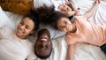 Top view of happy biracial family relaxing on bed Royalty Free Stock Photo