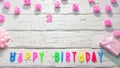 Top view of happy birthday 2 candle letters for a girl in pink shades with beautiful rose flowers, postcard congratulation copy Royalty Free Stock Photo