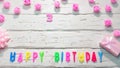 Top view of happy birthday 3 candle letters for a girl in pink shades with beautiful rose flowers, postcard congratulation copy Royalty Free Stock Photo