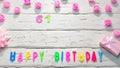 Top view of happy birthday 61 candle letters for a girl in pink shades with beautiful rose flowers, postcard congratulation copy Royalty Free Stock Photo