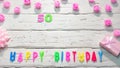 Top view of happy birthday 50 candle letters for a girl in pink shades with beautiful rose flowers, postcard congratulation copy Royalty Free Stock Photo