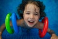 Top view of happy child wearing inflatable armbands playing in swimming pool. Summer vacation concept. Royalty Free Stock Photo