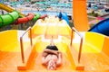 Top view of happy crazy man on top of slide in aqua park - Young people having fun in summer holidays - Vacation Royalty Free Stock Photo