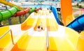 Top view of happy crazy man on top of slide in aqua park - Young people having fun in summer holidays Royalty Free Stock Photo