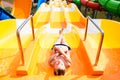 Top view of happy crazy woman on top of slide in aqua park - Young people having fun in summer holidays Royalty Free Stock Photo