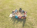 Top view of happy families doing picnic in park outdoor - Young parents having fun with children in summer time eating and playing Royalty Free Stock Photo