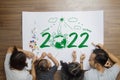 Top view happy family lying on floor, With creative painting 2022 New year earth eco environmental Royalty Free Stock Photo