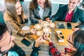 Top view of happy friends toasting cappuccino drink at coffee shop restaurant - Millennial people group having fun on breakfast Royalty Free Stock Photo