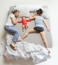 Top view of happy family with one newborn child in bedroom. Royalty Free Stock Photo