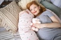 Top view happy future mother lying on comfortable bed hugging pillow for pregnant relaxing