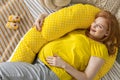 Top view happy future mother lying on comfortable bed hugging pillow for pregnant relaxing