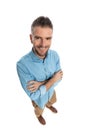 Top view of happy man in denim shirt crossing arms and smiling