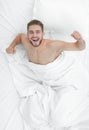 Top view. happy man waking up in a comfortable bed Royalty Free Stock Photo