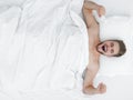 Top view. happy man waking up in a comfortable bed Royalty Free Stock Photo