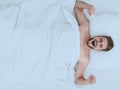 Top view. happy man waking up in a comfortable bed Royalty Free Stock Photo