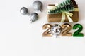 Top view of happy new year background with copy space, numbers 2022 and craft gifts on light background with christmas tree Royalty Free Stock Photo