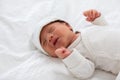 Top view happy newborn baby lying sleeps on a white blanket comfortable and safety.Cute Asian newborn sleeping and napping on bed.