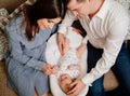 Top view. Happy parents with young son in a lounger for newborns. loving family