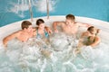 Top view - happy people relax in hot tub