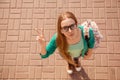 Top view of happy smiling woman in glasses showing v-sign Royalty Free Stock Photo