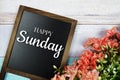 Happy Sunday text on blackboard with flower bouquet decoration Royalty Free Stock Photo