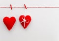 Top view Happy Valentines day concept with copyspace on white background. Two red felt pillow hearts hanging on the rope Royalty Free Stock Photo