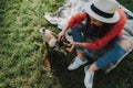 Young lady is sitting on plaid with her dog Royalty Free Stock Photo