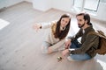 Top view of young couple with keys moving in new flat, new home and relocation concept.