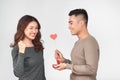 Top view of happy young couple looking at each other and smiling . Girl is holding a red paper heart Royalty Free Stock Photo