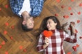 Top view of romantic couple lying on floor, expressing love to soul mate Royalty Free Stock Photo