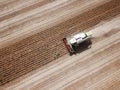 Top view of harvester harvesting genetically modified soya bean Royalty Free Stock Photo