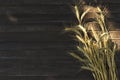 Vertical image.Ripe wheat stems on the wooden background.Natural light