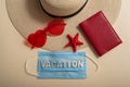 Top view on hat sunglasses passport starfish and mask with inscription Vacation. Travel concept during the spread of