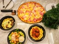 top view Hawaiian pan pizza, meatball penne and caesar salad in restaurant