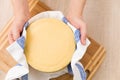 Top view on a head of fresh organic cheese in man`s hands. Food concept Royalty Free Stock Photo