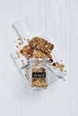 Top view on healthy breakfast homemade granola with nuts and sunflower seeds in open glass jar and energy bar Royalty Free Stock Photo