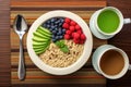 top view of a healthy breakfast: oatmeal, berries, and green tea