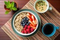 top view of a healthy breakfast: oatmeal, berries, and green tea Royalty Free Stock Photo