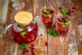 Top view of healthy detox water drinks with cranberries in glass jars with drinking straw on kitchen table with ingredients. Royalty Free Stock Photo