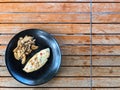 Top view of healthy egg white omelette with orinji mushroom on a black plate and wooden table Royalty Free Stock Photo