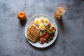 Top view of healthy food items bread slices, boiled vegetables and eggs