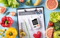 Top view of healthy food in plate with stethoscope and red heart for cholesterol diet and diabetes control on pastel blue Royalty Free Stock Photo