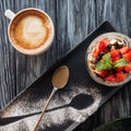 top view of healthy fruity dessert, spoon and cup of coffee