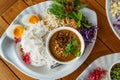 Top view healthy Thai food, Thai vermicelli or rice noodles with peanut sauce curry, side dish with organic vegetables, and boiled