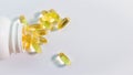 Top view Heap of capsules with oil close-up on white background, cod liver pills