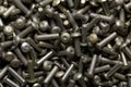 Top view of heap of dark gray steel rivets