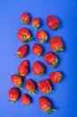 Top view of heap of fresh red strawberries on blue Royalty Free Stock Photo