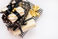 Top view of a heap of gift boxes in various black, white and golden designs. A concept of Christmas, New Year, birthday celebratio