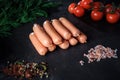 Top view on heap of long sausages with rucola and tomatoes
